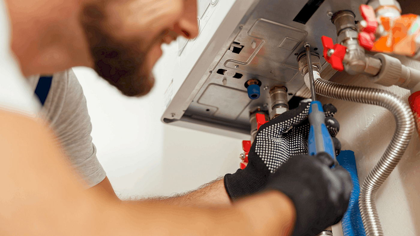 Heating engineer fixing faulty boiler unit - request a quote