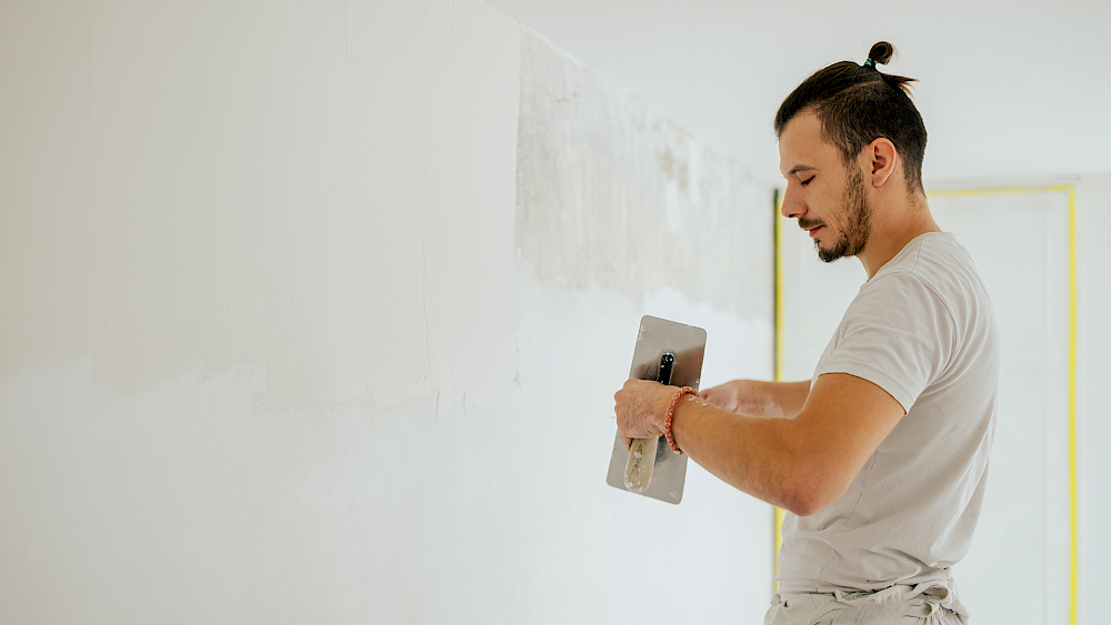 Plasterer skimming wall for smooth finish - request a quote