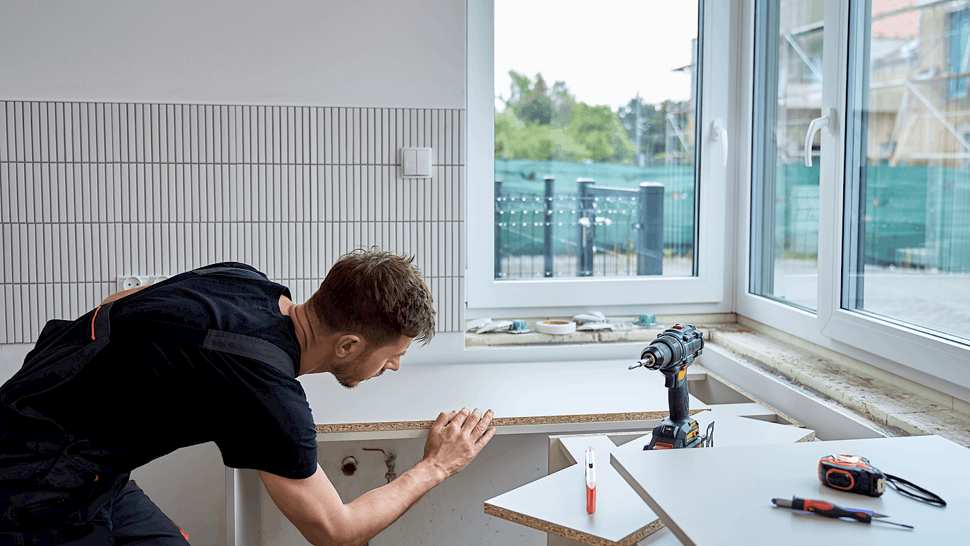 Carpenter installing wooden kitchen worktop - request a quote