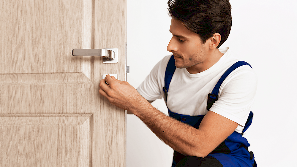 Carpenter installing wooden internal door - request a quote