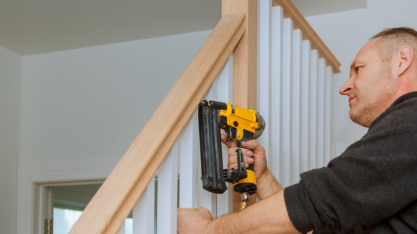 Carpenter fitting handrail and stair balustrade - request a quote